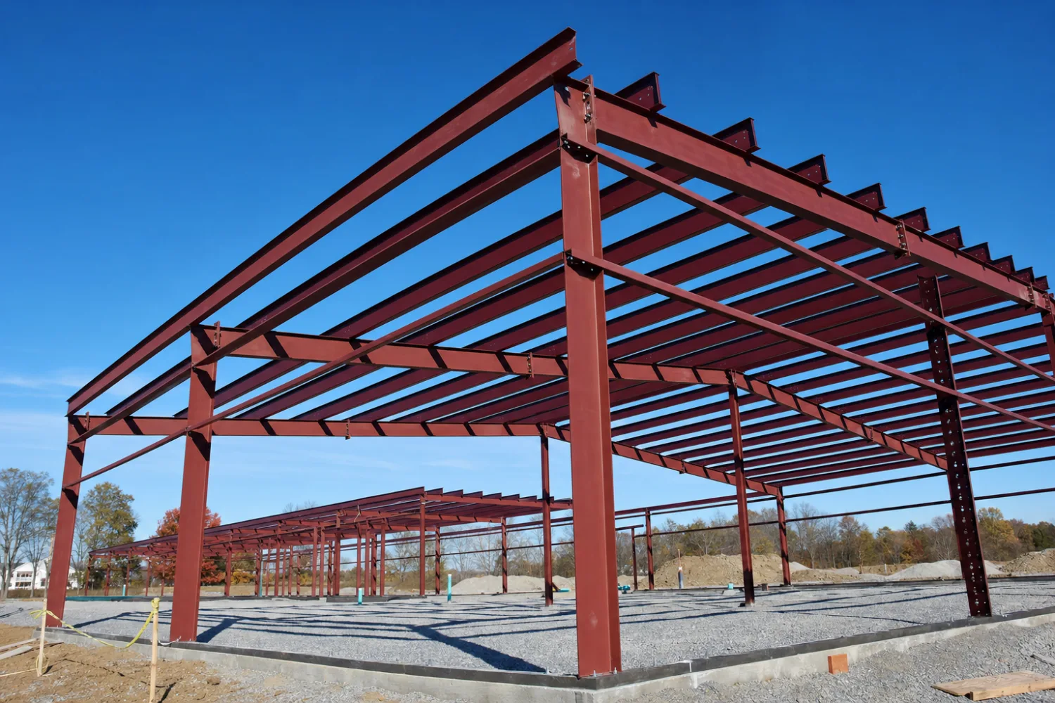 Red-iron metal building frame engineered to carry heavy Montana snow and wind loads